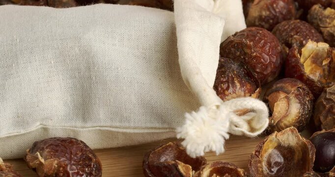 Soap nuts and eco laundry bag, close-up footage on a rotating table.