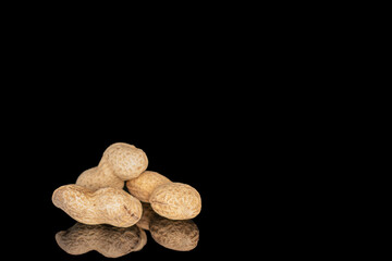 Unshelled peanuts isolated on black background, macro.