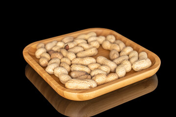 Unshelled peanuts isolated on black background, macro.