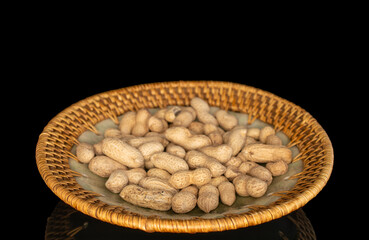 Unshelled peanuts isolated on black background, macro.