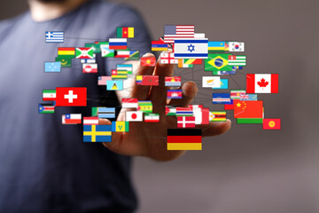 A hand reaching towards a network of international flags. Symbolizing global cooperation,...