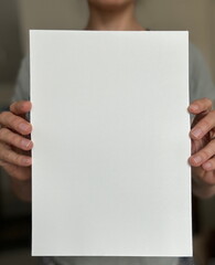 Close-Up of Hands Holding Blank A4 Paper in Soft Natural Light