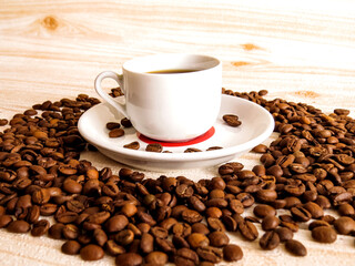 Cup of Coffee, Top view of coffee cup surrounded by roasted beans on wooden background. Minimalistic design for morning, cafe, or branding projects. Part of the Coffee Theme Pack series.