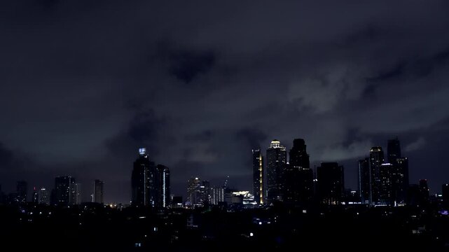 Time-lapse of Dark rain clouds rolling across the Bangkok skyline as thunder rumbles in the night.