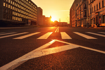 Empty street with pedestrian crossing at sunrise in Minsk © Alexander