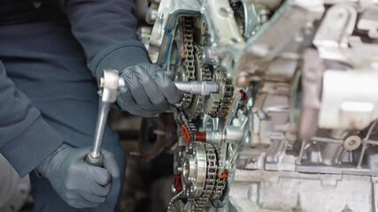 Close-up shot of a skilled mechanic tightening a bolt on an engine. Ideal for car service, repair tutorials, maintenance training, engineering content and technical documentation.