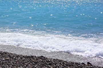 Beautiful view of wavy sea and pebbles on beach