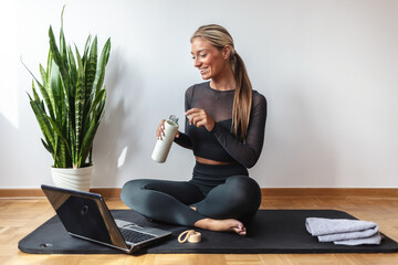 Home, fitness and woman with laptop, meditation and calm with workout, balance and wellness. Person, connection and girl in lounge, computer or spine training with health, stretching or virtual.