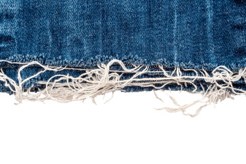 Piece of torn denim on a white background. Denim texture