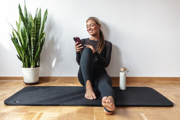 Woman, smartphone and smile with exercise break in house, influencer and social media comment...