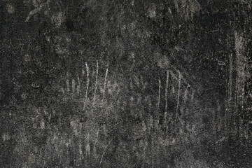 The old wall is stained with black stains and scratches from animals, cats climbing the wall.