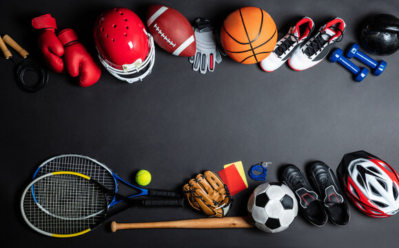 Variety of Sports Equipment Displayed on Dark Surface for Training and Recreation