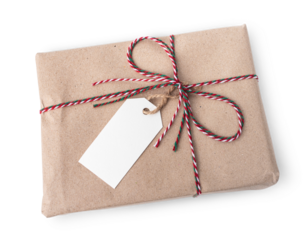 Gift box wrapped in brown kraft paper tied with red, white and green string in shape of bow with tag for text isolated on transparent background or png file.