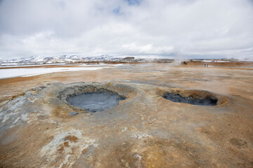 mud pools and smoking fumaroles at Hverir geothermal area, North Iceland