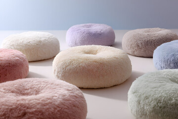 fluffy cushions arranged in a perfect zen circle creating soft pastel calmness and peaceful minimal interior design