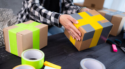 Girl Packing Cardboard Box At Home
