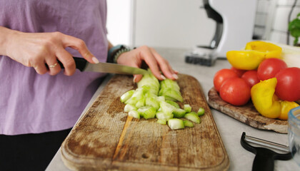 Girl Cutting A Cucumber On A Cutting Board