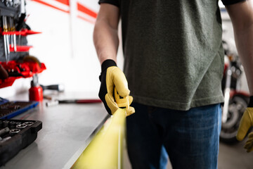 Worker Holding Measuring Tape In Hands