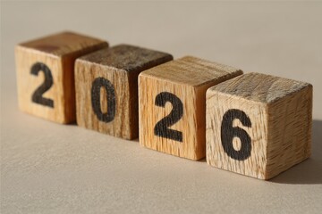 2026 Wooden Blocks: A close-up shot of wooden blocks displaying the year 2026, symbolizing anticipation and future planning. The wooden blocks create a rustic aesthetic.