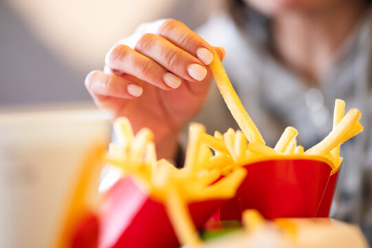 Girl Eating French Fries At Mcdonald's
