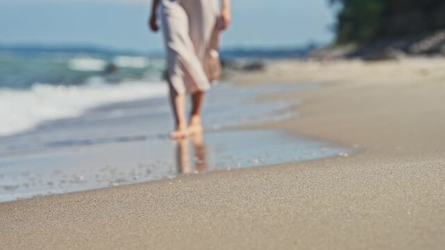Woman Walking Barefoot Along Baltic Sea Sandy Shore on Sunny Day