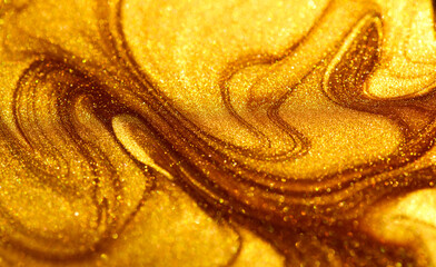 Beautiful abstract golden liquid paint background, beauty gold backdrop texture. Metallic gold paint, art design. Yellow shimmering surface close-up. Golden bright glitter texture macro shot. Top view