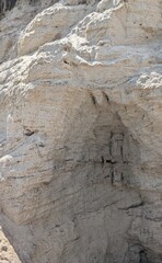 Close-up of a natural sand cliff texture with visible erosion layers and soft sunlight. Perfect for background, geology, nature, and texture design projects.