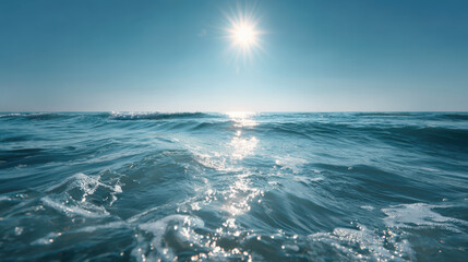 Calm sea with gentle waves and bright sunlight reflecting on water, creating serene and peaceful atmosphere