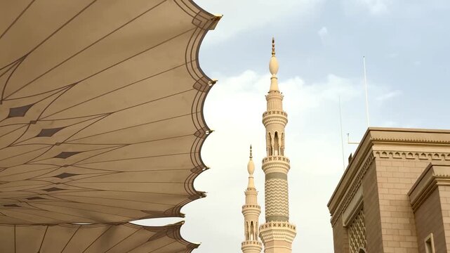Large architectural umbrellas and minaret at Al-Masjid an-Nabawi in Medina