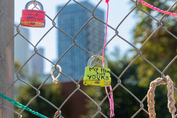 Locks inscribed by affordable-housing activists are seen on the fence of a Toronto property vacant for 17 years. The activists say they will not be locked out of housing by profit-driven developers.