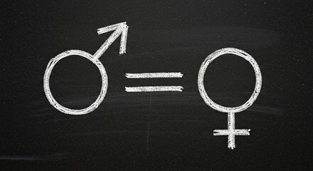 Symbolizing gender equality and equal opportunity, chalked male and female symbols form a powerful message of unity and shared value on a dark blackboard
