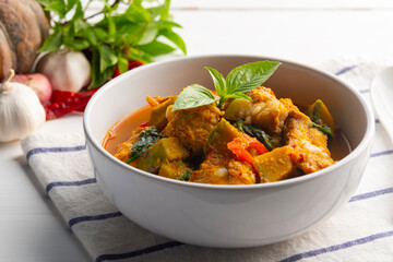Spicy Pumpkin Soup,Red Curry Pumpkin with Pork Baby Back Ribs or pork cartilage in white bowl.Thai food.