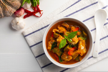 Spicy Pumpkin Soup,Red Curry Pumpkin with Pork Baby Back Ribs or pork cartilage in white bowl.Thai food.Top view.