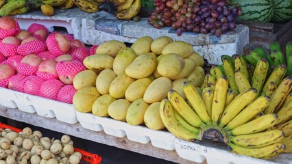 Colorful display of organic products at retail market, colorful display featuring oranges, bananas and nuts arranged attractively, vibrant colorful display appealing to shoppers, ideal for retail 