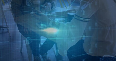 Two colleagues tapping tablet and gesturing over coffee at wooden cafe table, with digital overlay