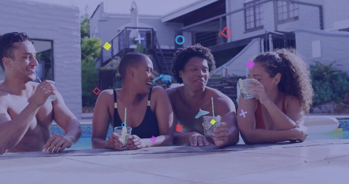 Leaning group of four friends sipping cocktails at backyard pool near ladder, with patio furniture