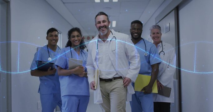 Walking group of healthcare staff wearing scrubs and coats down hospital corridor, with DNA overlay
