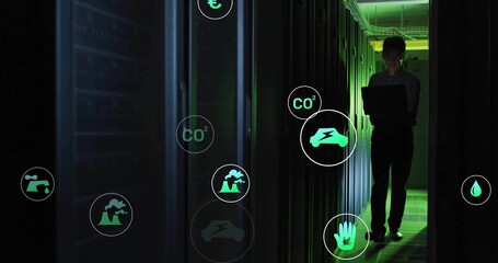 Technician checking server energy in data center corridor, with glowing icons on laptop, copy space