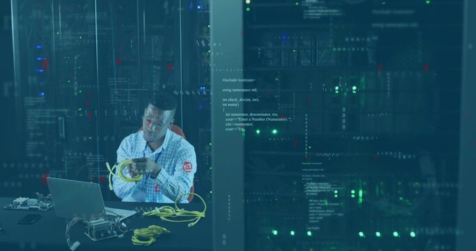 IT technician arranging Ethernet cables in server room racks with laptop, switch, copy space