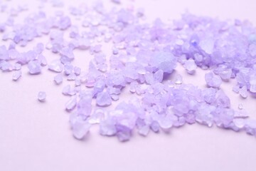 Sea salt on violet background, closeup view
