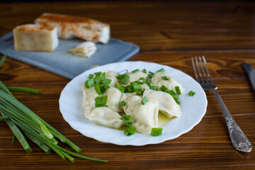 Healthy serving of dumplings with potatoes on a wooden surface