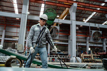 Fototapeta premium A man in a grey and white uniform is working in a factory