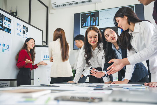 Group of young asian businesswomen discussing new business projects during a meeting in a modern office