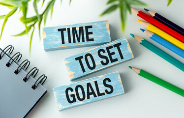 A wooden block with the words Time to Set Goals written on it