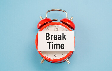 A red alarm clock with a white sign that says Break Time on it