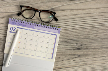 Desktop calendar for February 2026 on a gray background with a copy of the copy.