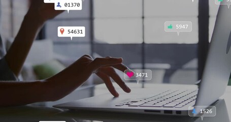 Woman resting hands on keyboard at business desk receiving notification bubbles and sipping juice - Powered by Adobe