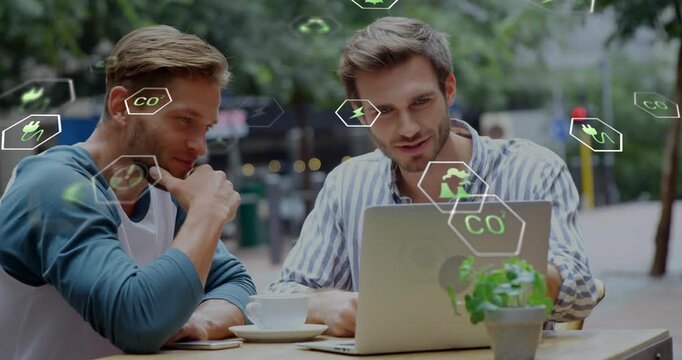 Two men clicking laptop at outdoor cafe starting green analysis session with animated eco icons