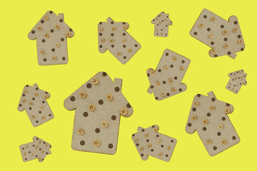 decorative wooden houses on a yellow background. wooden Toys. housing and construction concept