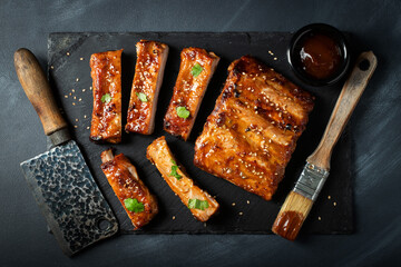 Barbecue pork spare ribs with hot honey chili marinade on black background